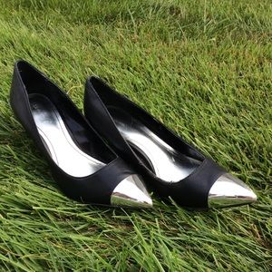 Women’s black leather heels with silver tips